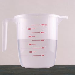 Kitchenware. Measuring cup with water.