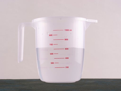 Kitchenware. Measuring cup with water.