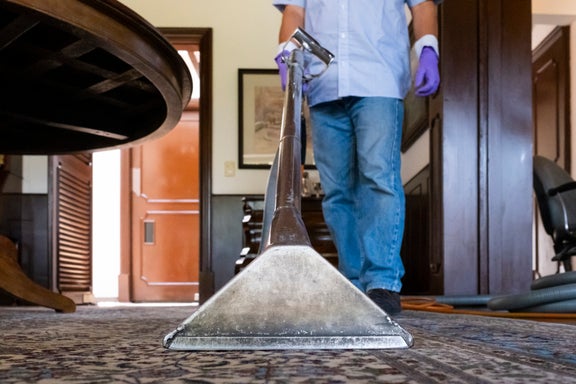 housekeeper cleaning carpet