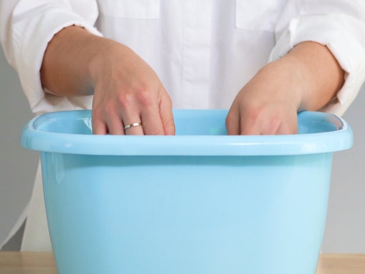 peron soaking something in a bucket